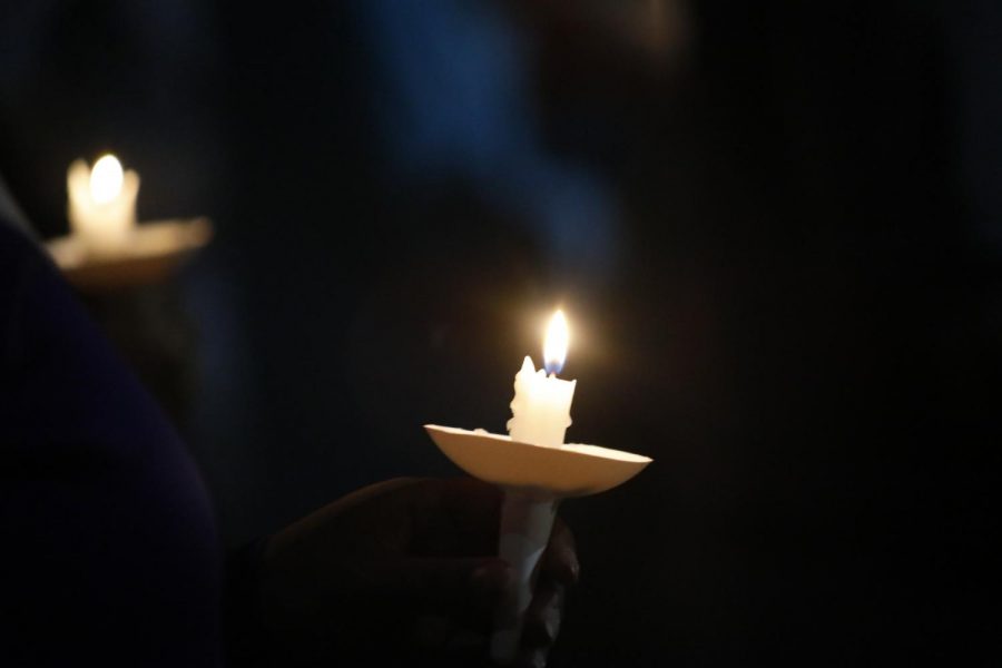 A candle held by a community member in remembrance