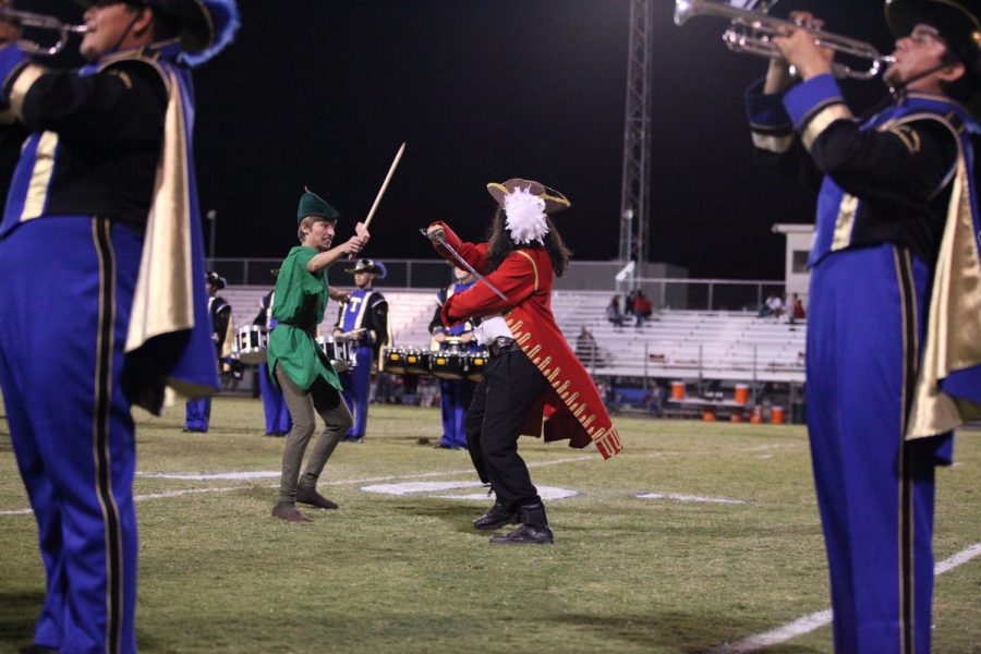 Peter Pan (Dawson Lopez) and Captain Hook (Eulysses Urrea) fight with swords during the halftime show.