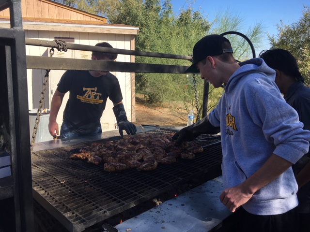 Oil Tech Seniors Ethan Roberts and Beau Gongora helping with the barbecue.
