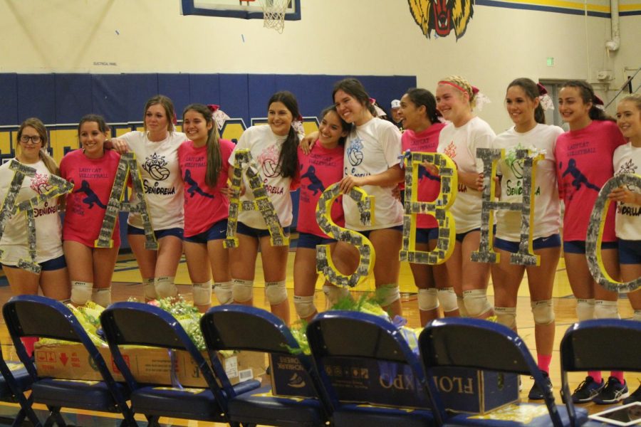 The Varsity seniors holding up their surprise with their teammates. 