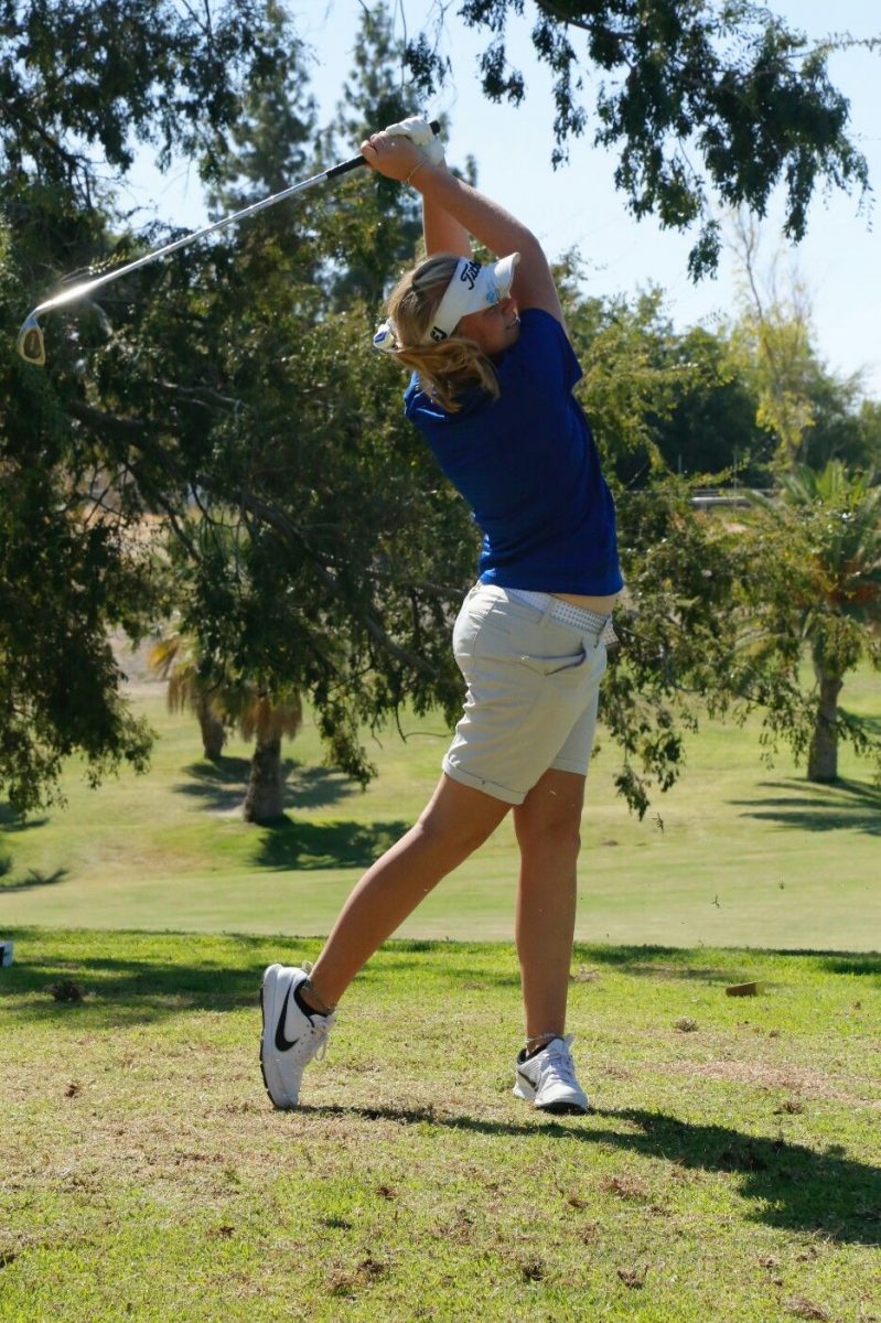 Sierra Pilgrim hitting an iron at the Buena Vista Golf Course.