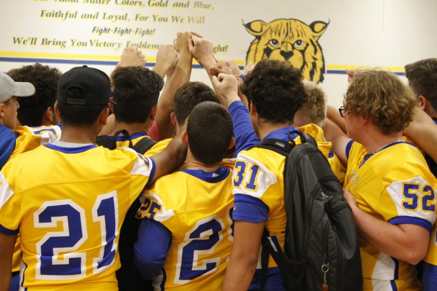 The Varsity team showed enthusiasm after they were introduced to the school and came together for a chant.