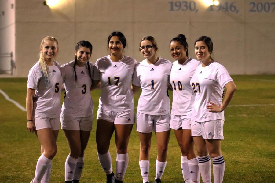 All the senior girls at their last soccer home game before they graduate.