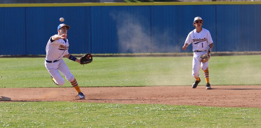 Wildcat outfielder Reese Hammons and second baseman Chad Berry throwing the ball back and fourth to get runners out at home on 4/10. 