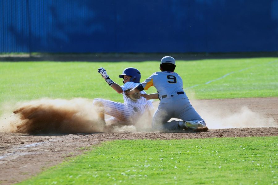 Reese Hammons sliding into third base after stealing it.