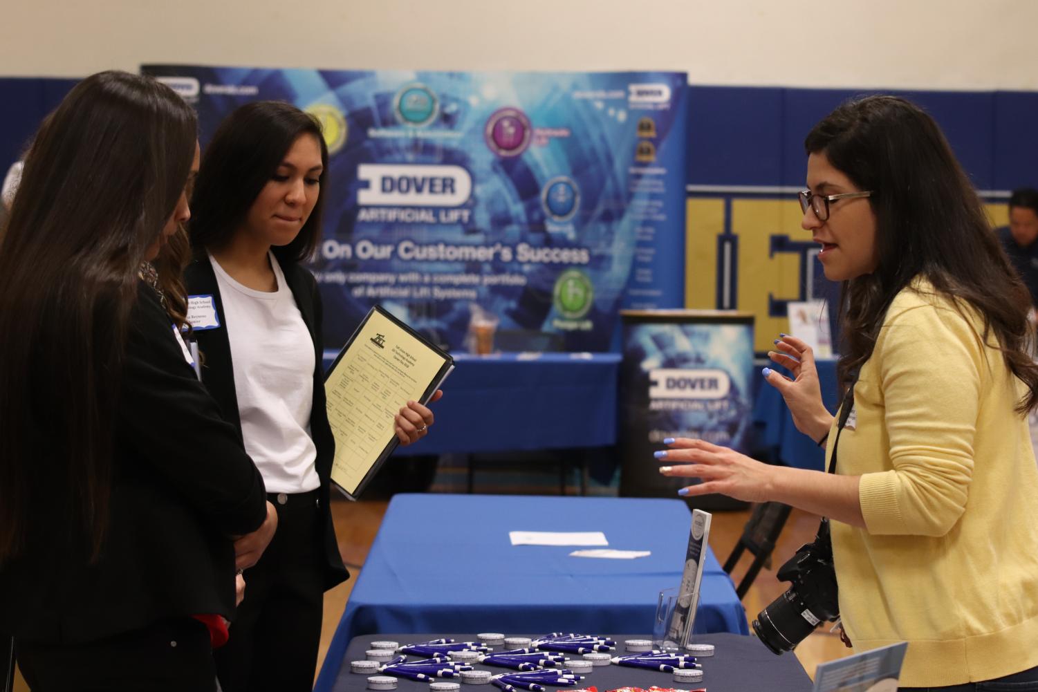 Millie Reynoso learns more about Providence Strategic Consulting, Inc. alongside another Oil-Tech student.