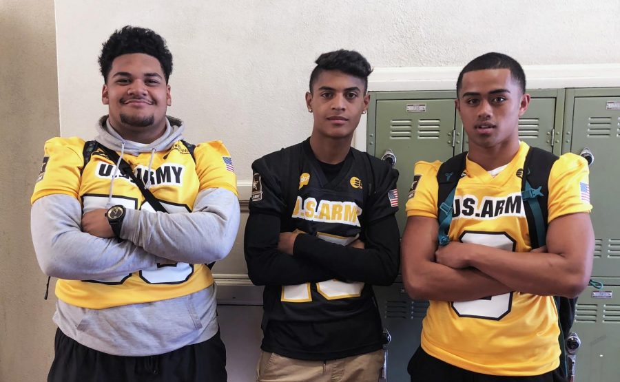 Maino, Tualia, and Maui pose in their Army Bowl jerseys.