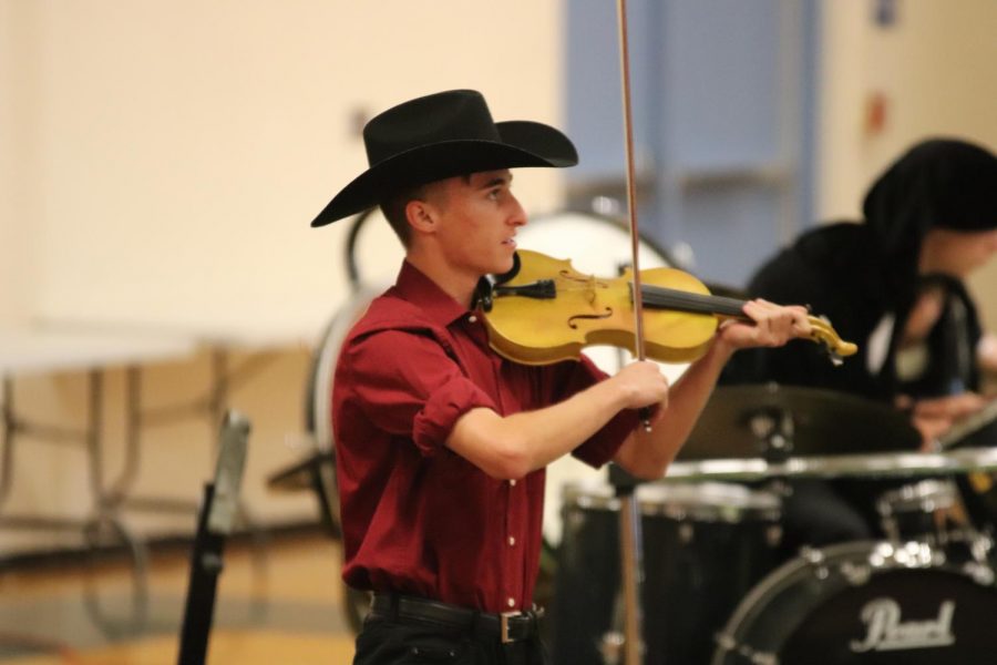Dawson Lopez playing the violin while dressed as the Devil. 