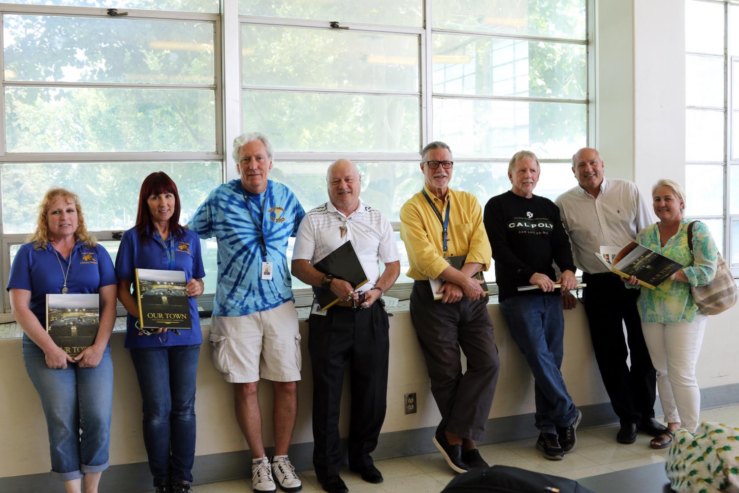 Lisa Polk, Karen Hillygus, Jim Carnal, Scott Bennett, Ben Johnson, Gene Conners, David Skowron, and Julee Skowron receiving the yearbook dedicated to them (Harold Heiter, not pictured).