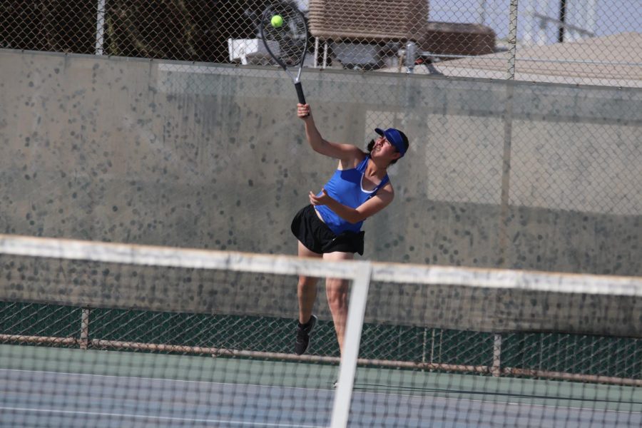 Serving it to her opponent. Diana Huizar is setting the ball to start the match. Dianas family supports her by showing up to her most of her home matches.