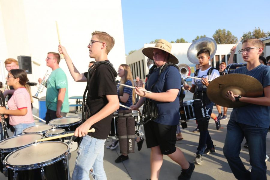 The percusssion portion of the band makes their way to the band room after their performance at back to school night. Some songs they played were Seven Nation Army, Irresistible, Confident, and Happy. 