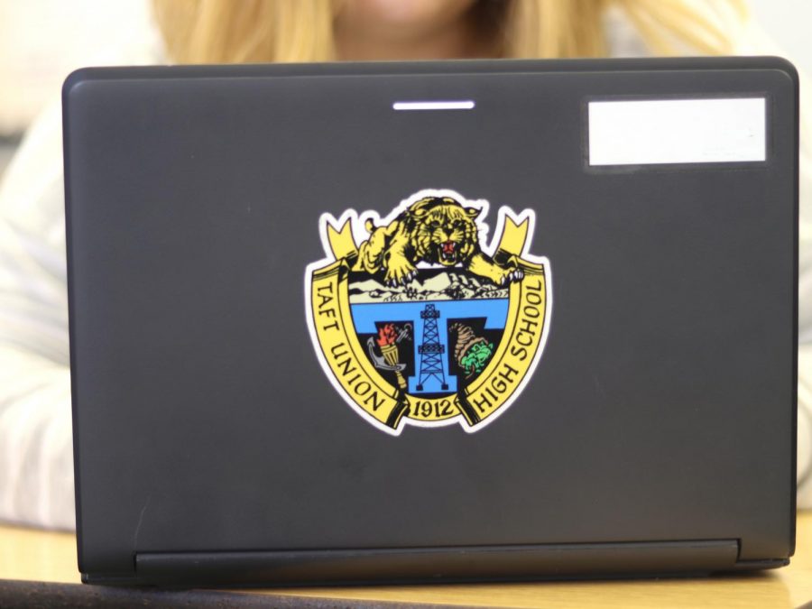 (Photo credit: Thalia Villanueva) Tesla Barnes troubleshoots a school laptop. Trouble with Wi-Fi is persistent. “Sometimes a restart will fix it” Jodi Jackson, an I.T. representative suggests.