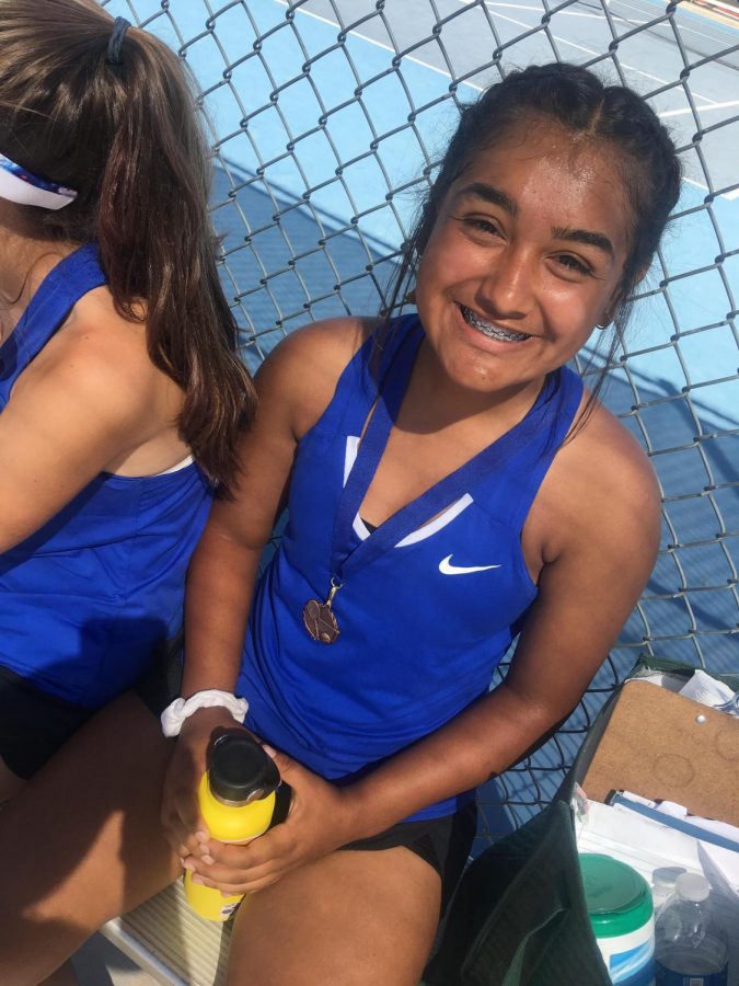 Showing off. Sophomore Angelica Brown showing off her bronze metal. She is always trying her best in every match. 