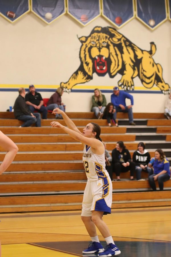 Morgan Pulido is on the line shooting two free throws for the team thanks to the opposing teams foul. She is photographed during the middle of shooting a free throw. 