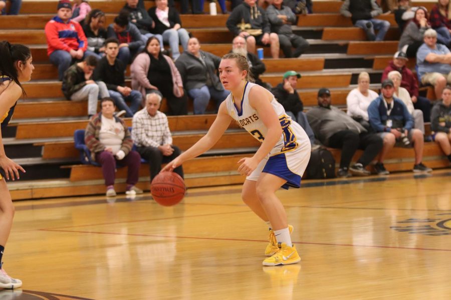 Macayla Wells is doing her job as point guard and slowing down the play so that her teammates can get into their positions and set up their offense. 