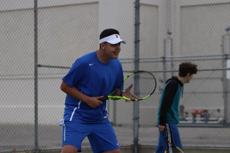 Senior Juan Guerrero in his playing stance as his opponent serves the ball. Juan was able to win his game in two sets and later won in doubles as well.