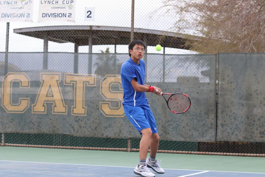 Singles #2 Tyler Nyguen swinging his racket at the ball. Tyler won his match in the third set 10-7. 