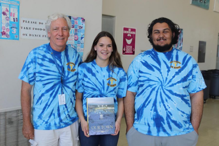 2018 Adviser Jim Carnal, Co-editor Hunter Everson, and co-editor Carlos Margis show off the yearbook cover at the yearbook dedication and distribution last May. 