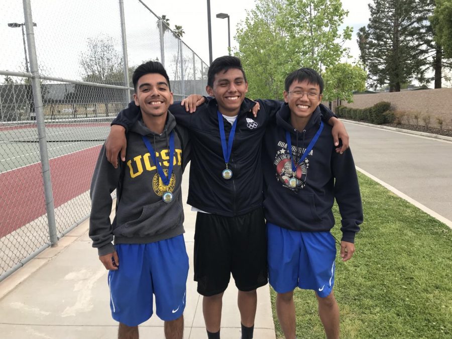 All smiles for seniors Brian Rivera, Rudolpho Magana, and Tyler Nyguen as they wear their SSL champion medals. All three players qualified for the area tournament where they hope to win as well.