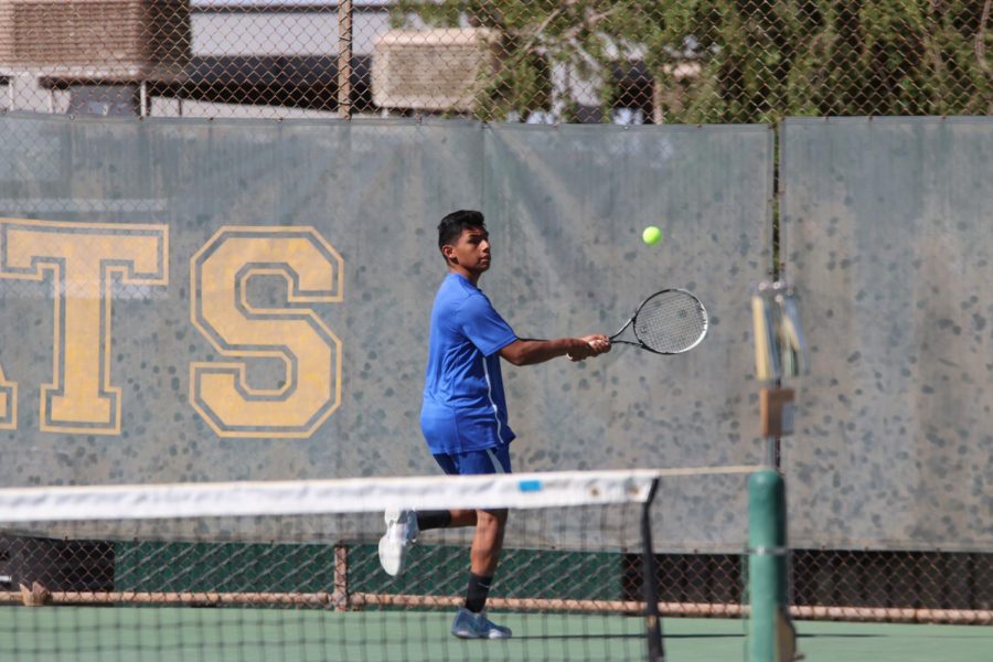 Senior Rodolfo Magana backhands the ball after a serve. He played well and has had a great season.