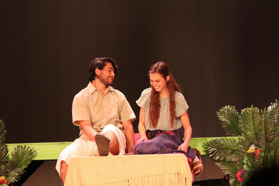 Daniel Beauxhomme (Eulysses Urrea) and Ti Moune (Kenya Orsburn) sitting and talking with each other.