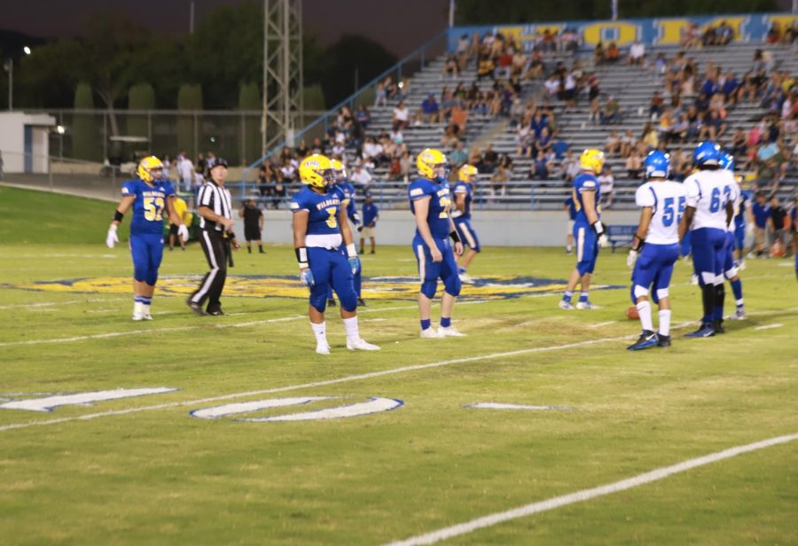 It is 2nd down and 5 and the Wildcats defensive line stands up trying to make a huge stop. This photo includes Walker Maino(#3),Bryce Veach(#24) Derek Amorteguy(#17), and Jacob Ellis(#19).
