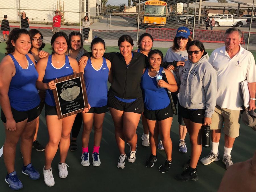 TUHS varsity tennis players and coaches, Bill and Linda Friend, posing with their 2nd valley plaque. 