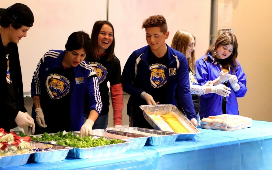 Students from the foods club was handing out food for the students who achieved a 4.oo or higher.  