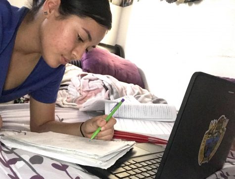 Miriam Guzman is shown writing down notes for her classes. Guzman said her favorite thing about online school is, being able to do work at whatever time of day you want.