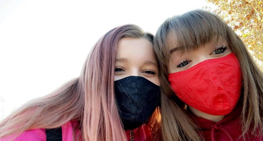 Raven Yeager and Taylor Virgilio posing outside of campus on the first day back as juniors waiting to go through the cafeteria gate.