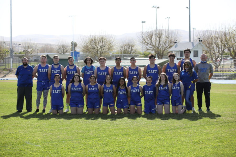 Track and field team posing for a photo.